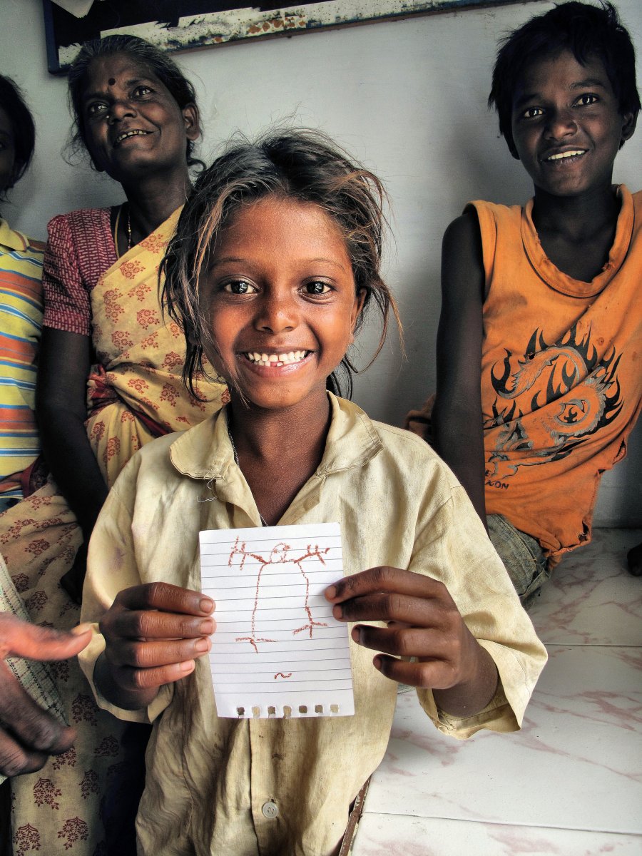 Jayanthi, pictured on the same day she was rescued from slavery in the rock quarry. She received an official release certificate declaring her free, and the picture she holds was the first drawing she had ever made.